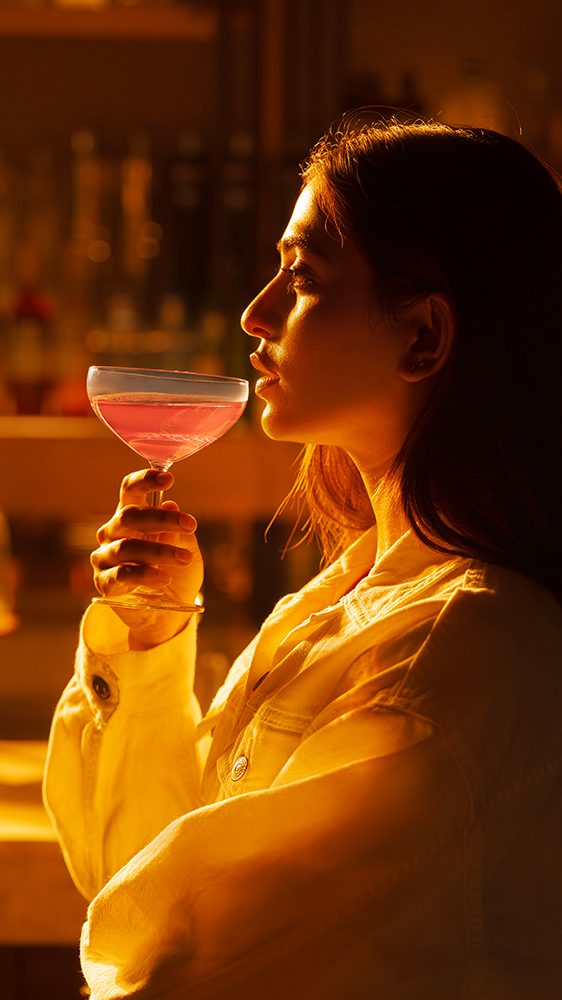 Guest enjoying a cocktail at Park Hyatt Hyderabad luxury bar warm ambient lighting hospitality lifestyle photography